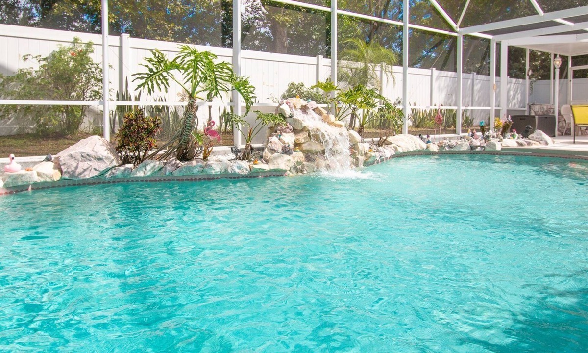 Chatham Park House | 3 Bedroom Home with Private Screened Pool with Rock Waterfall Feature and Gameroom by Florida Dream.