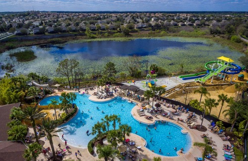 Windsor Hills Condo | Modern condo in resort, 5 min to Disney. WiFi, water slides, pool, arcade!